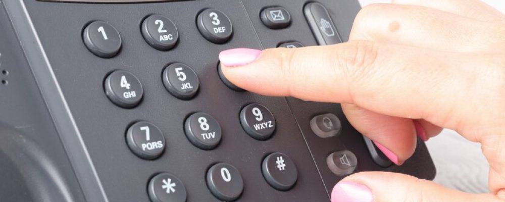 close-up-finger-dialing-make-phone-call-office_155165-9331